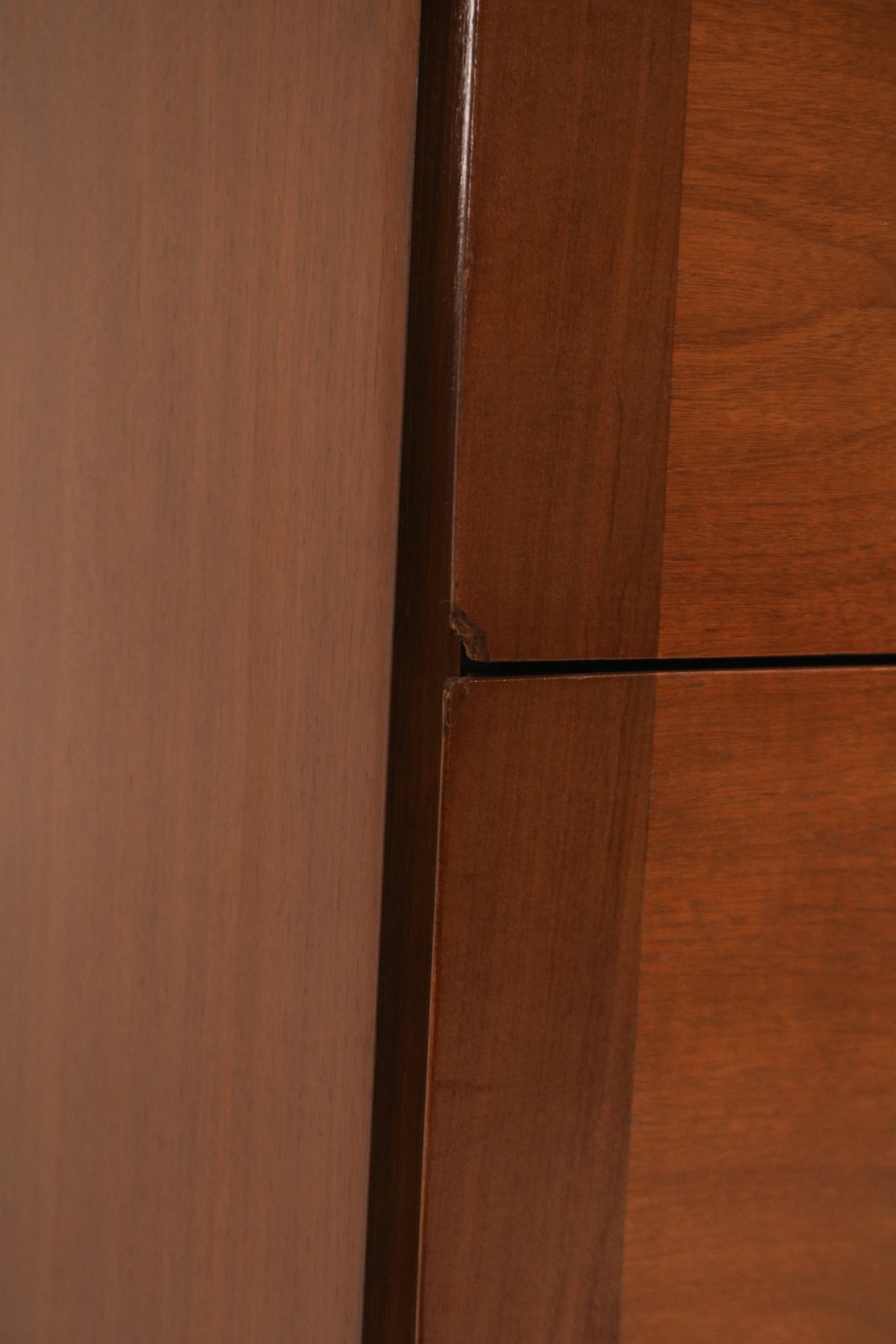 Detail of the distinctive circular metal drawer pulls on the lower drawers