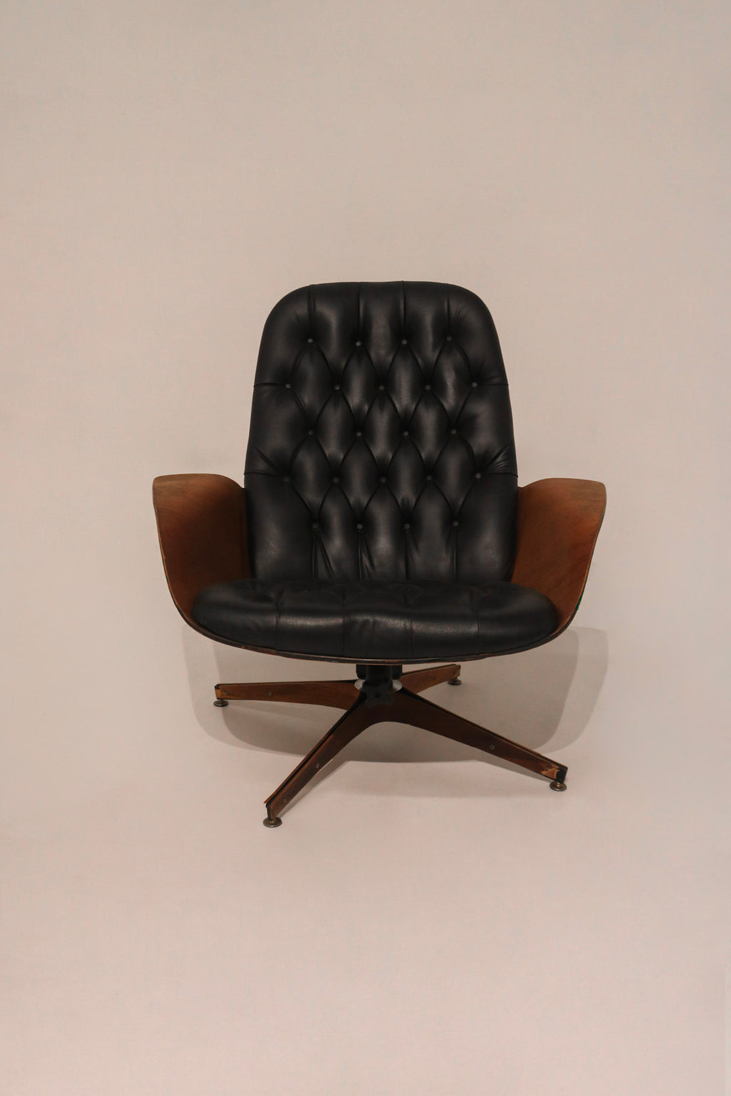 Detail of the curved plywood armrest and its junction with leather upholstery