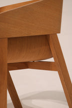 Close-up of curved backrest joinery showing precision woodwork