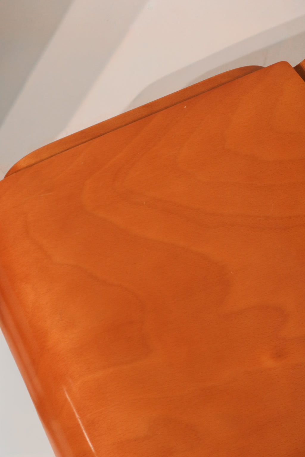 Rear view of curved plywood backrest showing ergonomic design