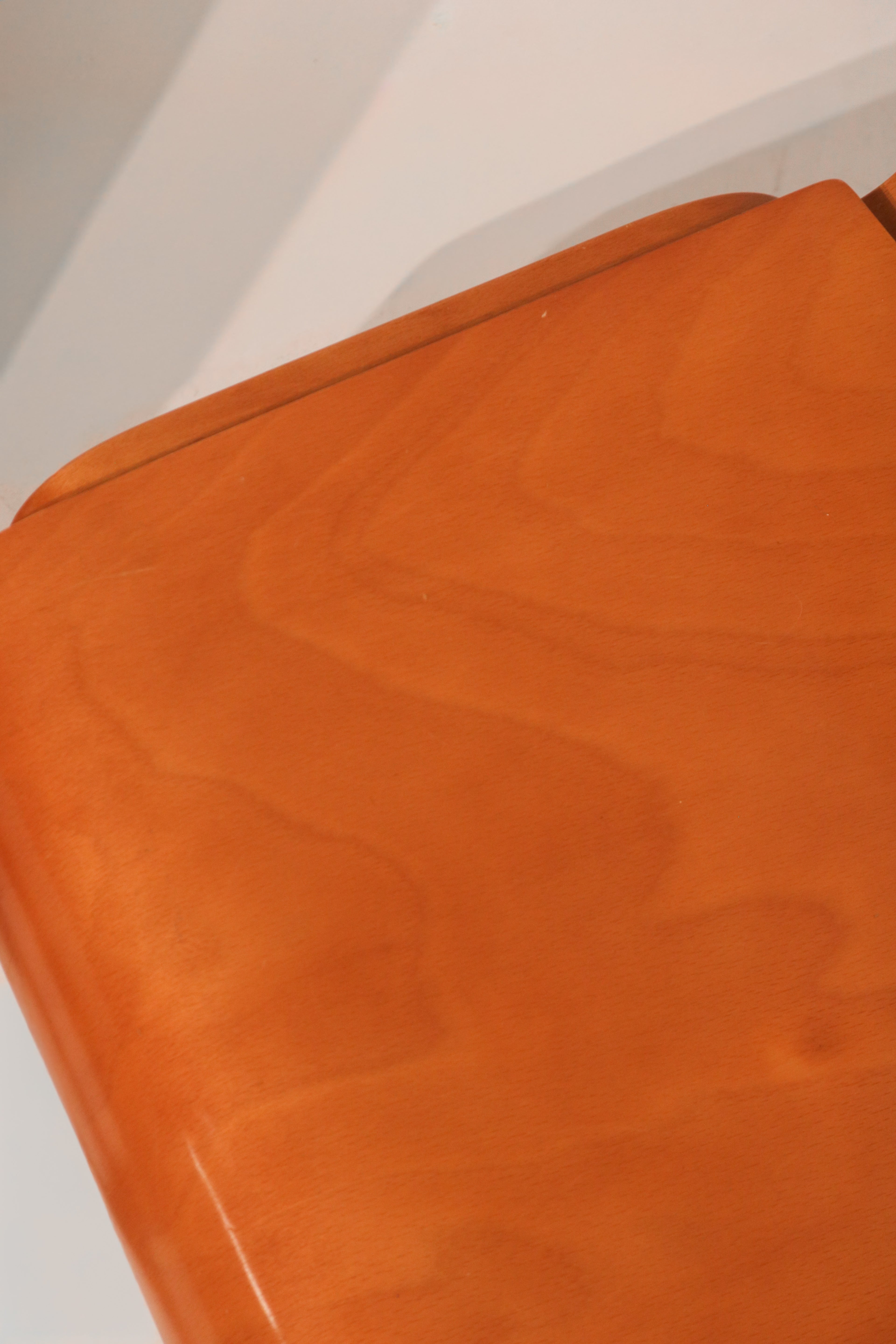 Rear view of curved plywood backrest showing ergonomic design