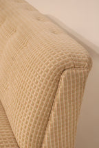 Top edge detail of curved backrest showing smooth upholstery lines