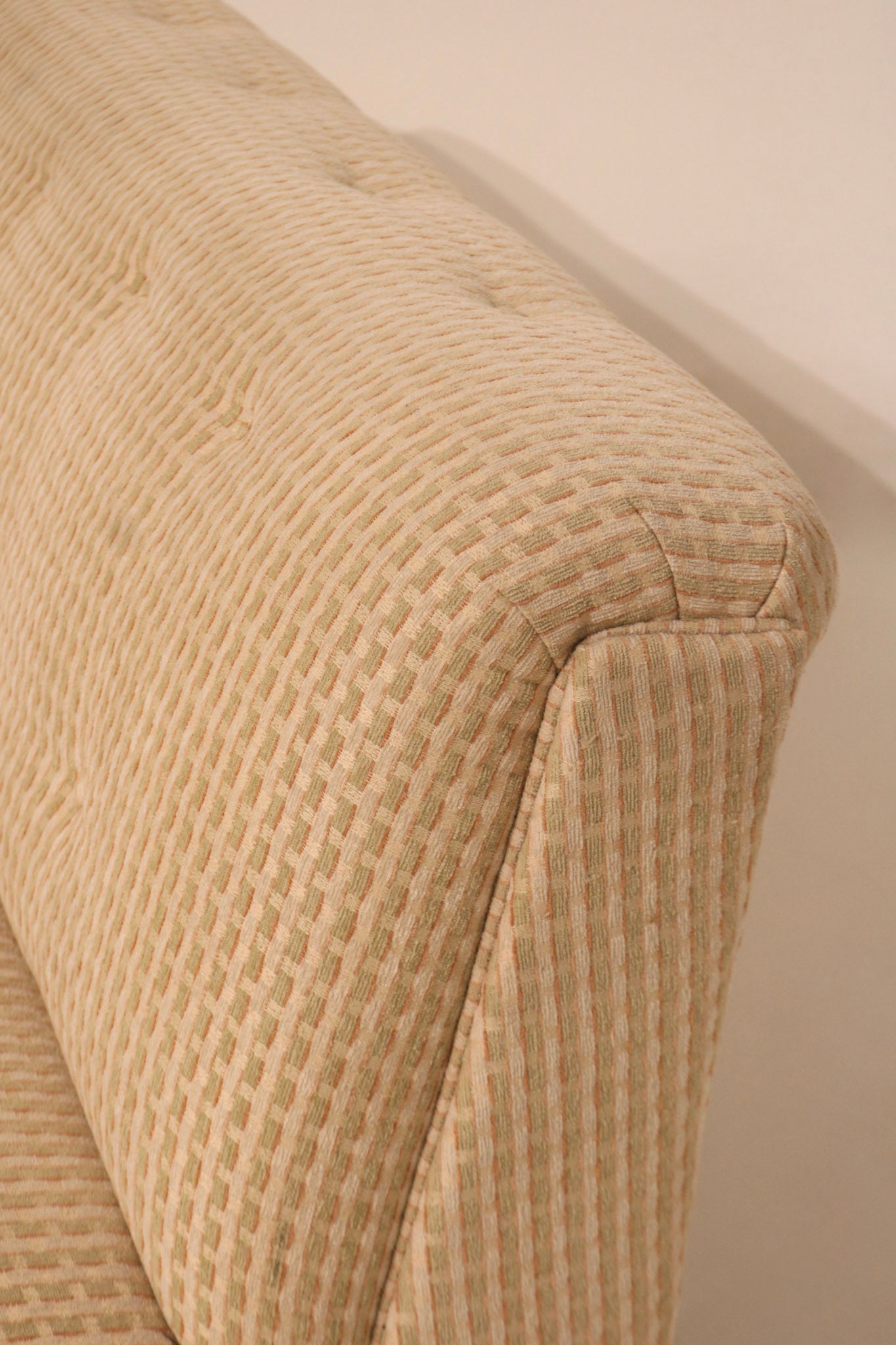 Top edge detail of curved backrest showing smooth upholstery lines