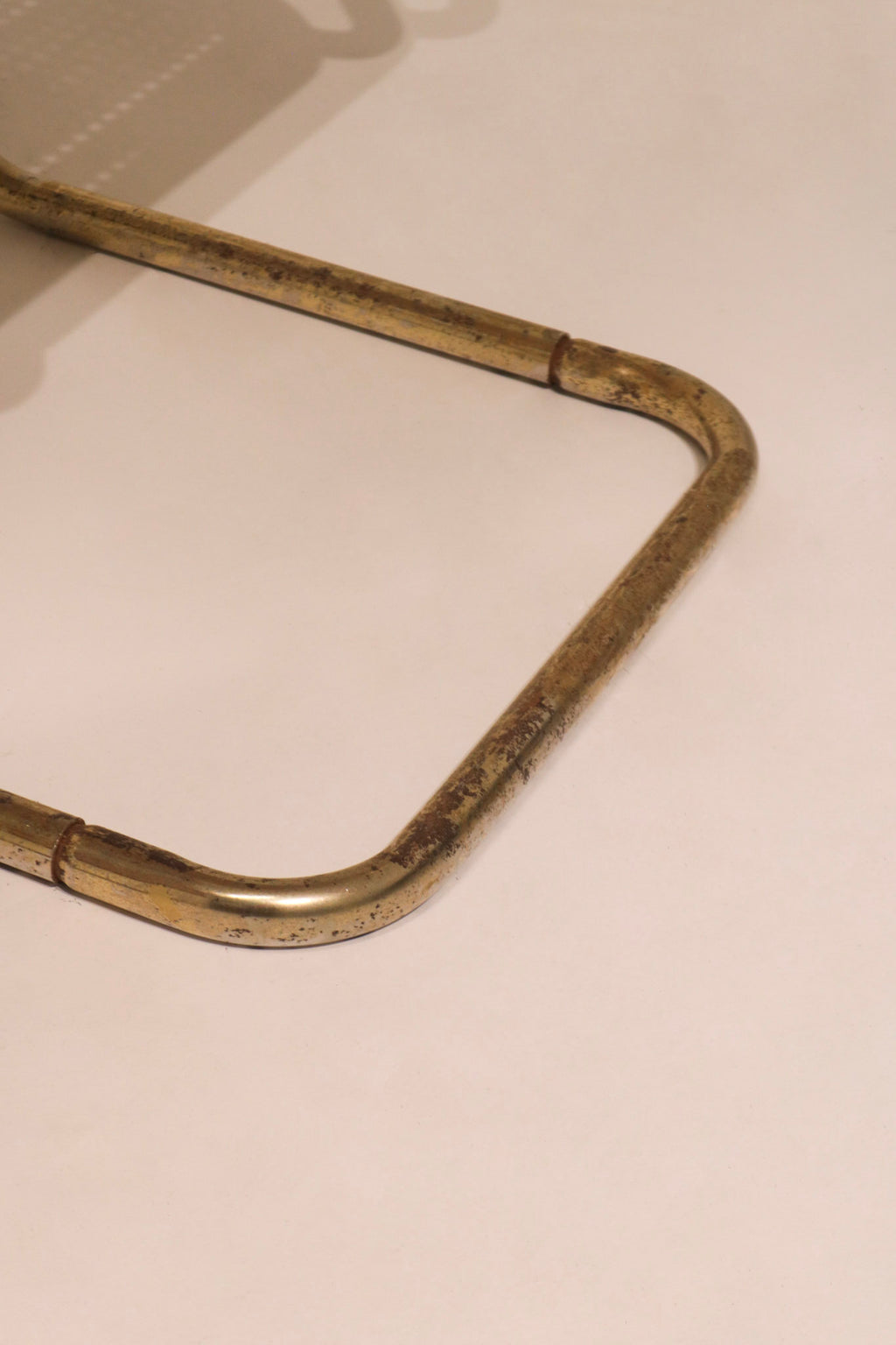 Close-up of curved metal frame joint construction on chair base