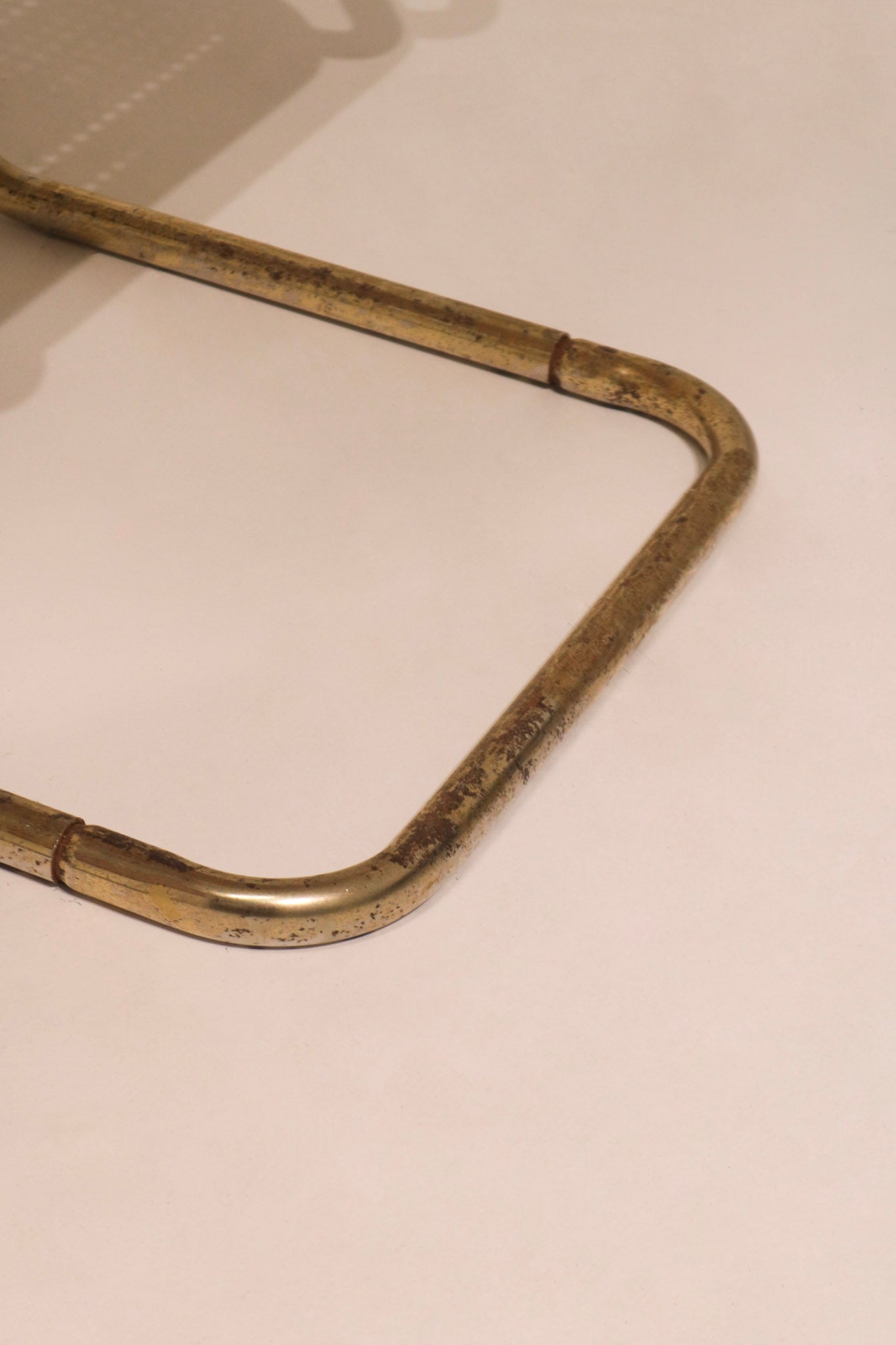 Close-up of curved metal frame joint construction on chair base