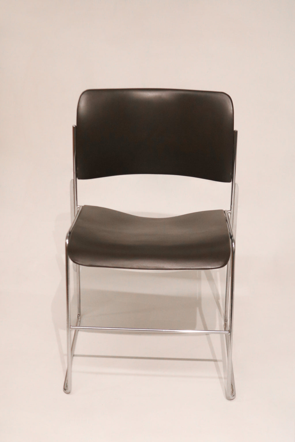 Front view of single David Rowland 40/4 chair showing chrome frame and black seat