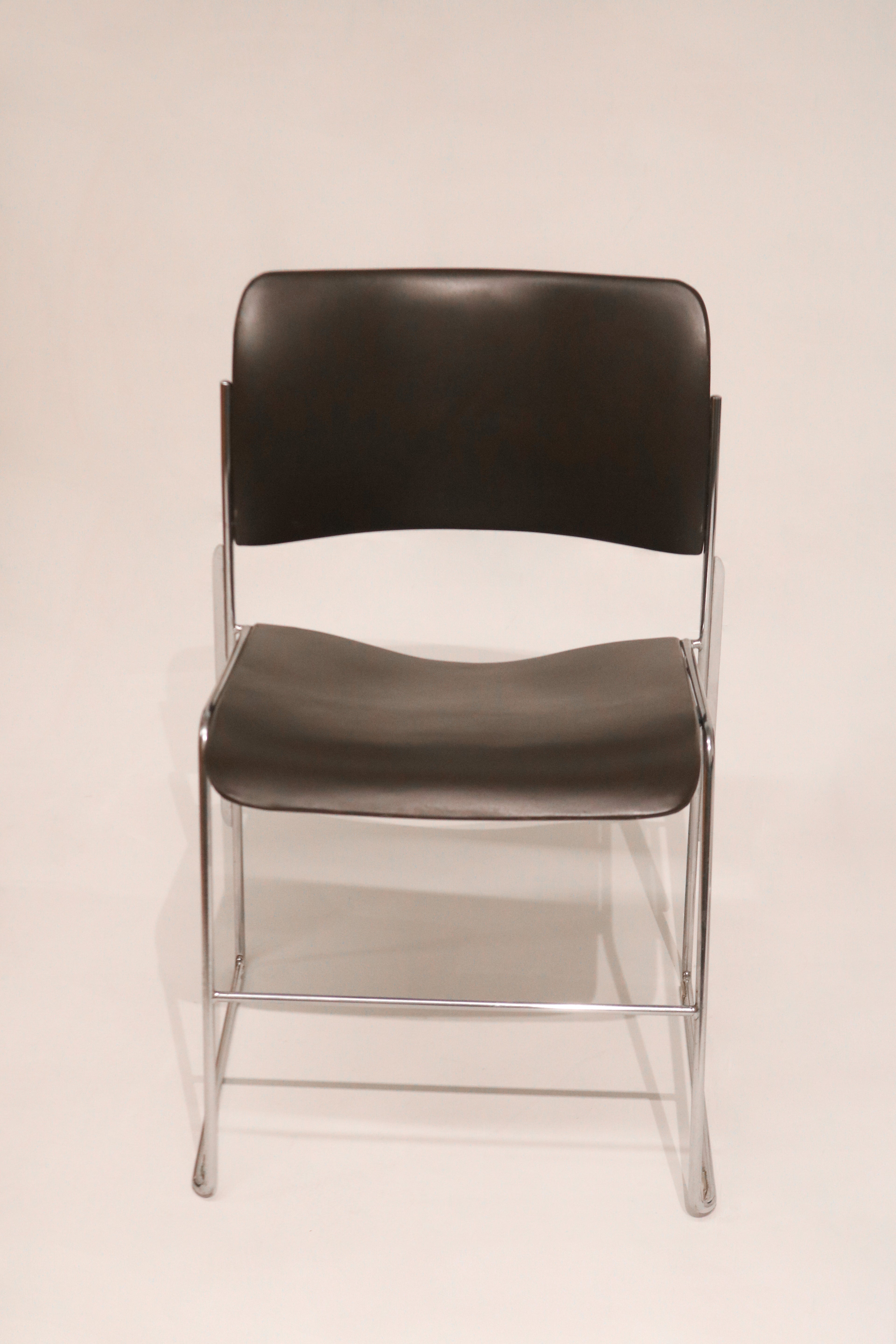 Front view of single David Rowland 40/4 chair showing chrome frame and black seat