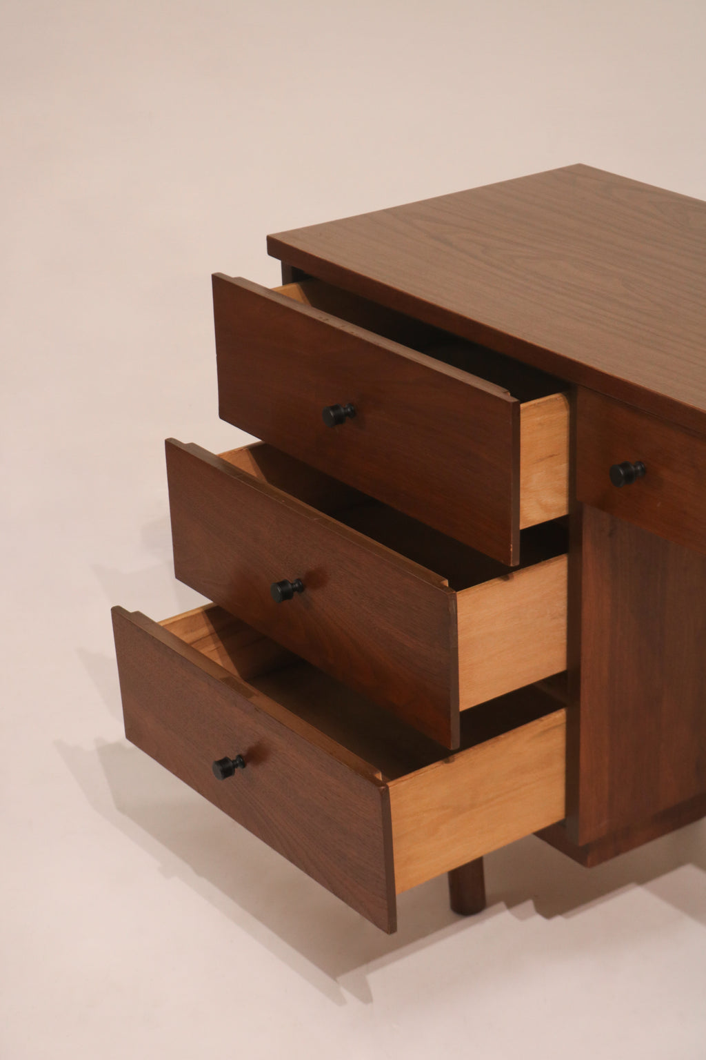 Side view of desk drawers open showing storage capacity and structure