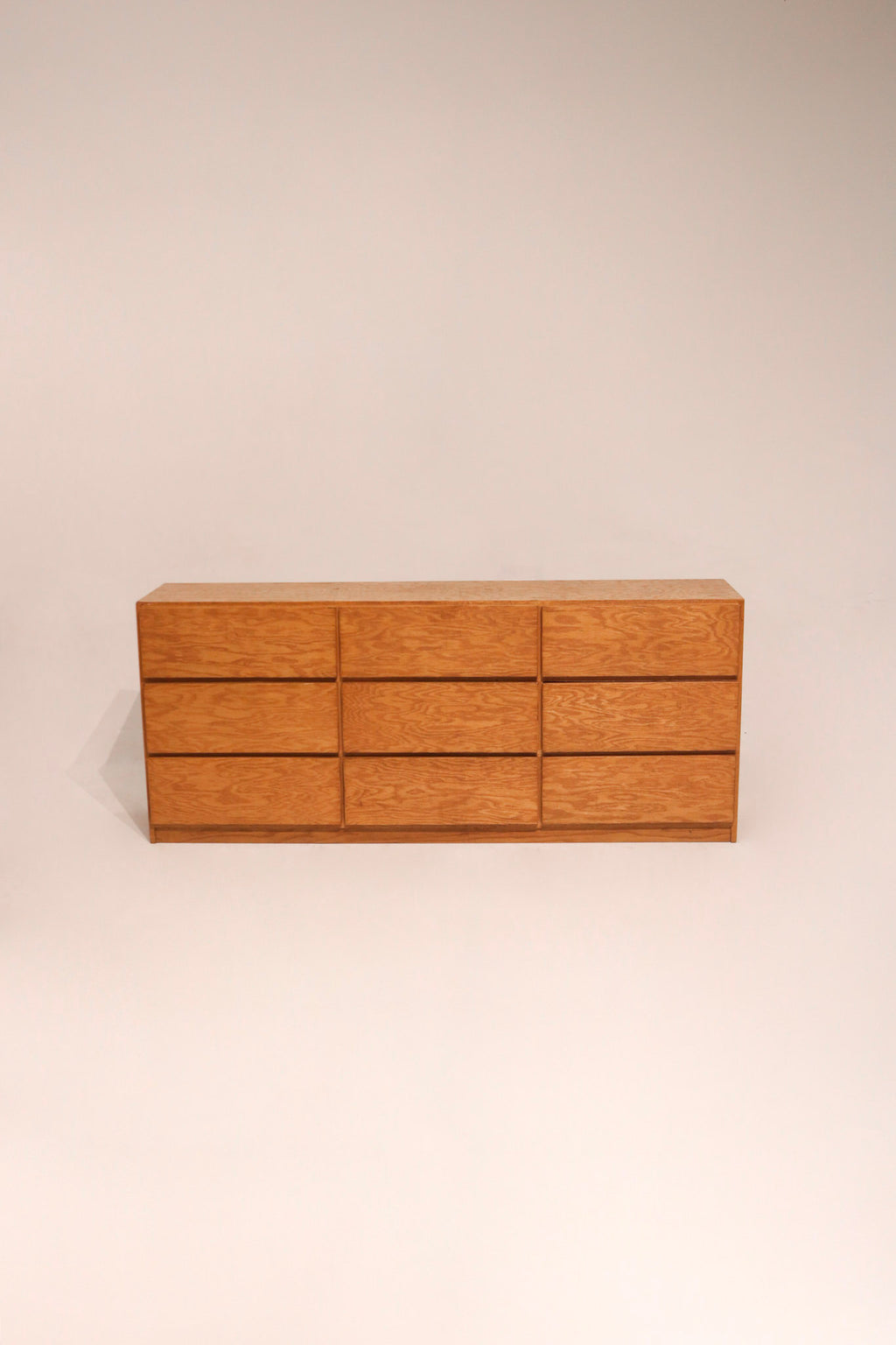 Full view of vintage solid oak 9 drawer dresser with warm wood tones and classic design
