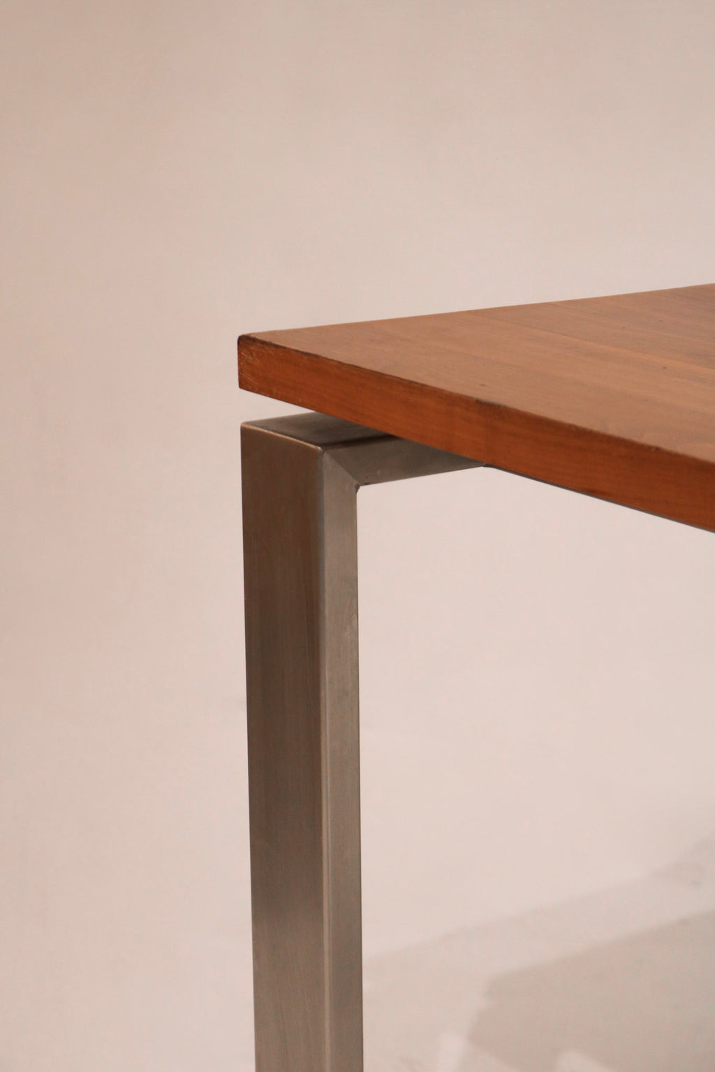 Diagonal angle shot capturing full table in natural lighting and showcasing rich wood tones