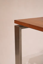 Diagonal angle shot capturing full table in natural lighting and showcasing rich wood tones