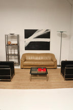 Side angle of black leather and chrome LC2 chair highlighting minimalist structure