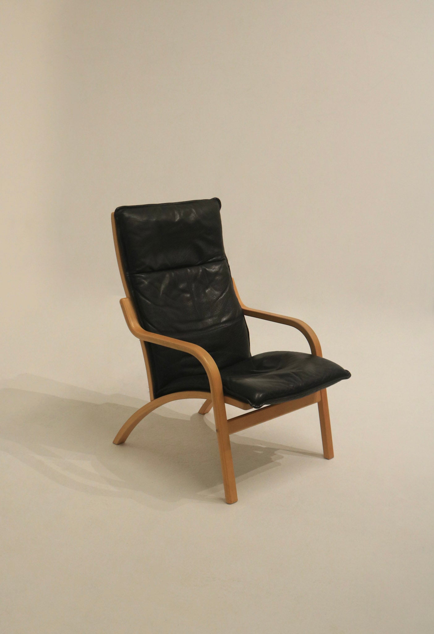 Authentic vintage Danish lounge chair with dark leather upholstery