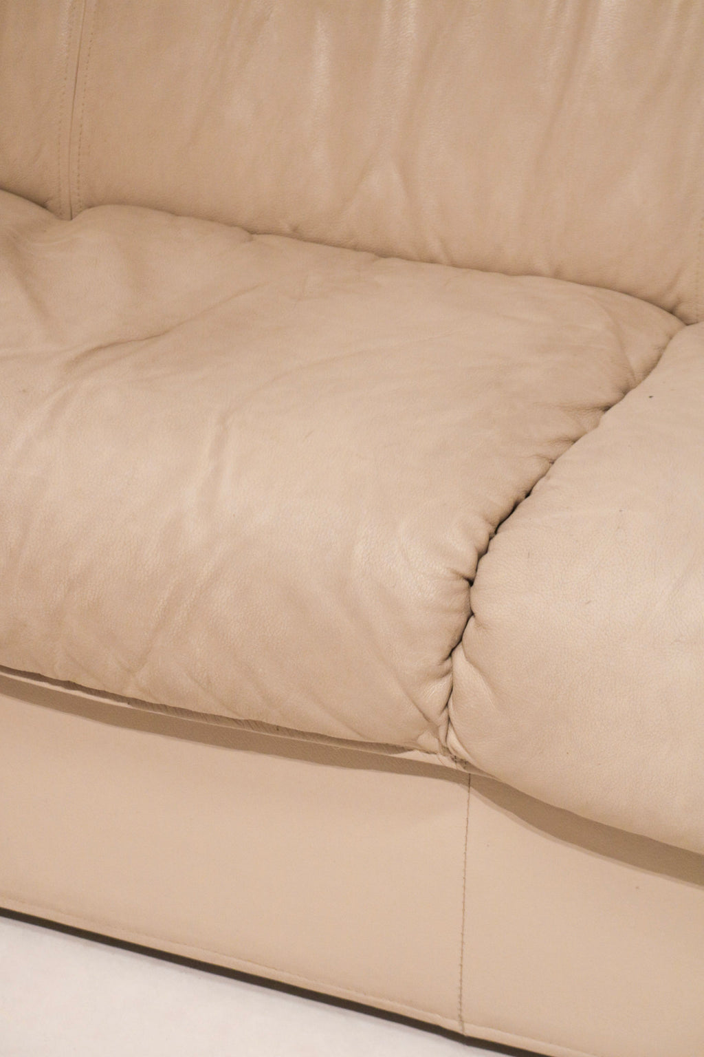 Back bottom area of the leather Natuzzi couch showing minor wear as described