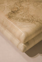 Heavy and sculptural resin legs of the Italian coffee table with bold marbled design