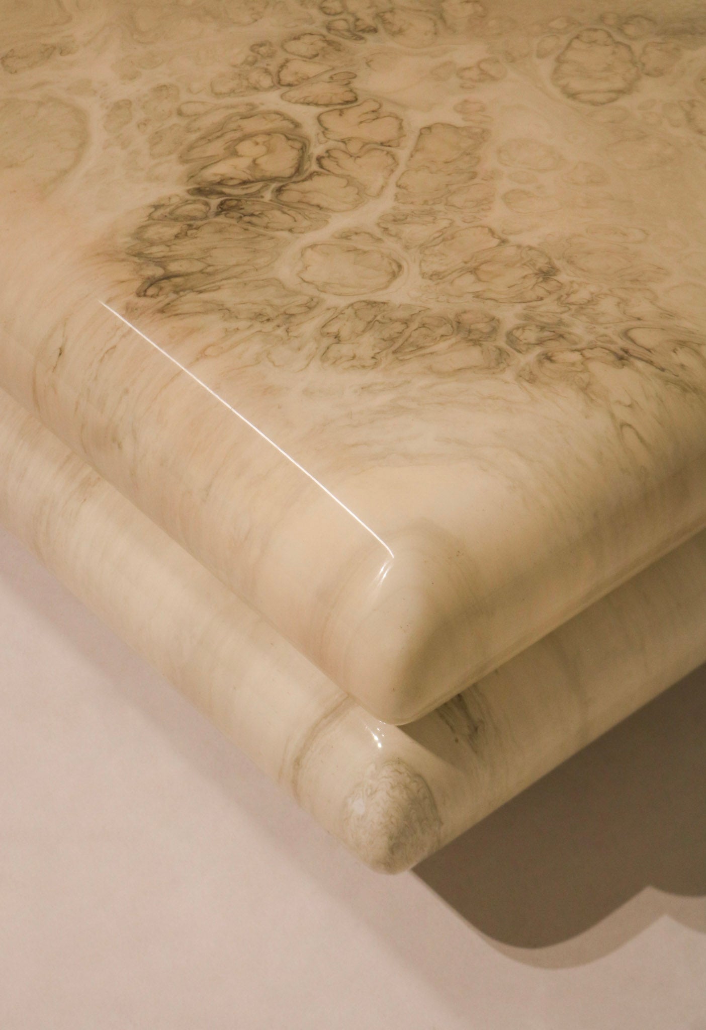 Heavy and sculptural resin legs of the Italian coffee table with bold marbled design