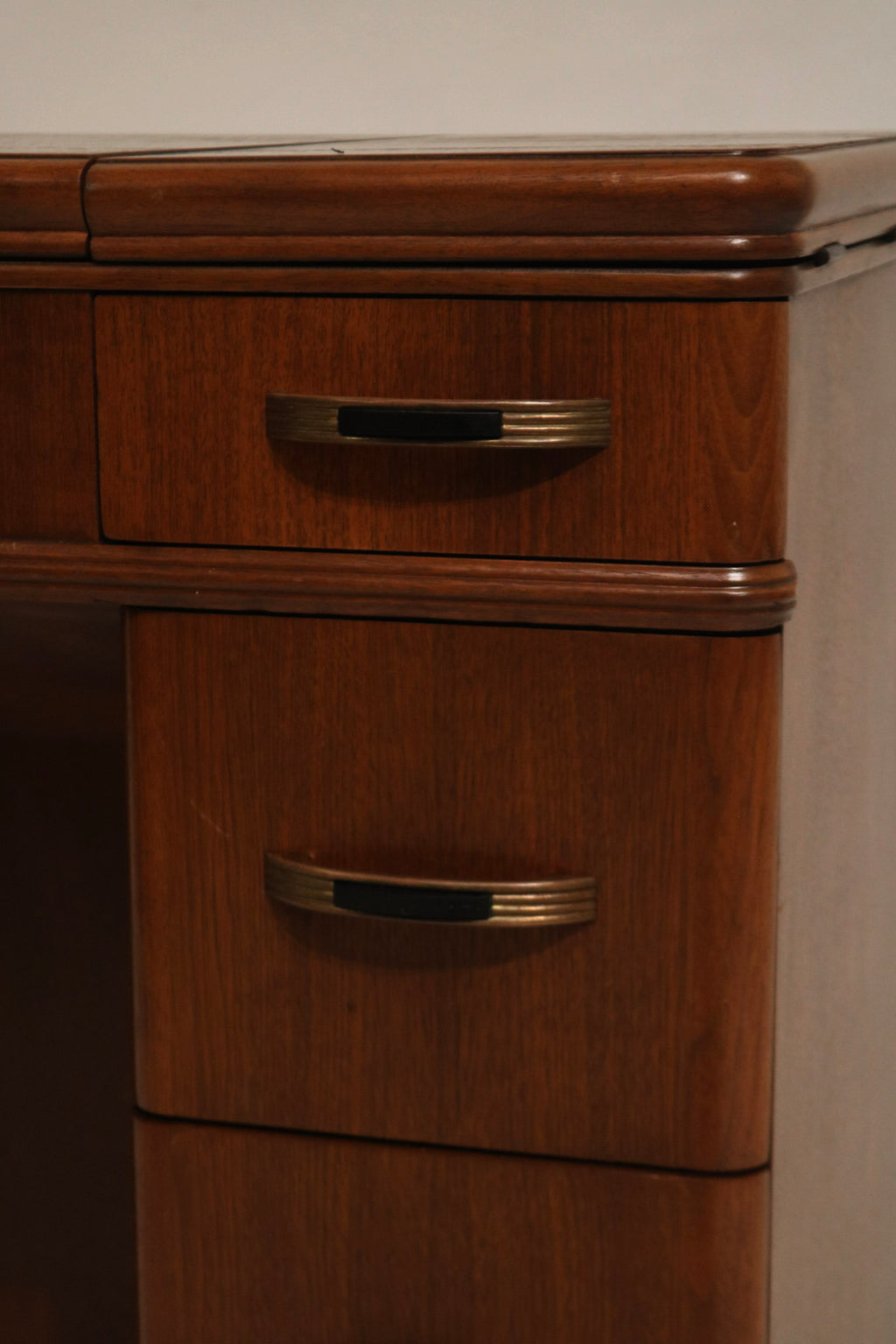 Side angle view of walnut wood vintage desk showing two leaves, drawers and compact footprint perfect for small apartments