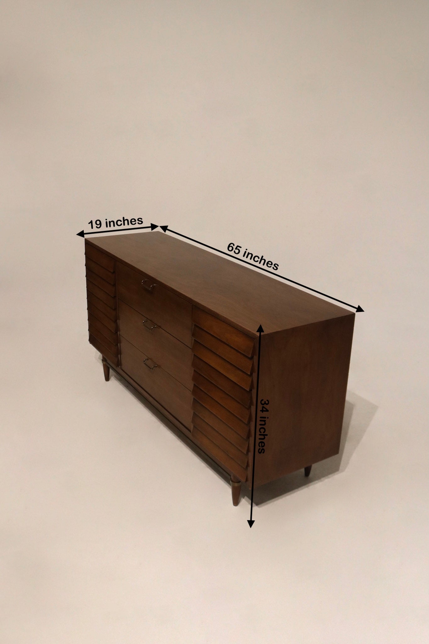 Size view of walnut solid wood dresser with dimensions 65L x 19D x 34H showing scale and profile