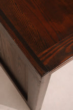 Angled shot of the desk legs made of solid oak wood with vintage finish