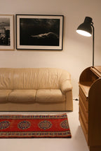 Angled shot of vintage leather Natuzzi sofa showing depth and seating layout