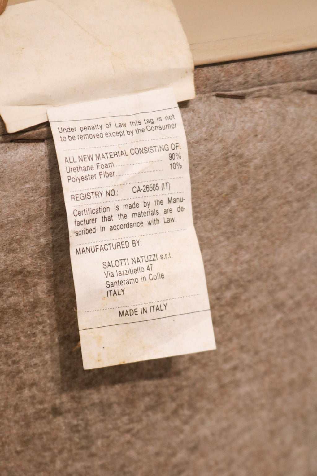 Close-up of genuine Italian leather upholstery texture on Salotti Natuzzi sofa in beige color