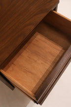 Leg detail of nightstand revealing tapered mid-century modern wood construction