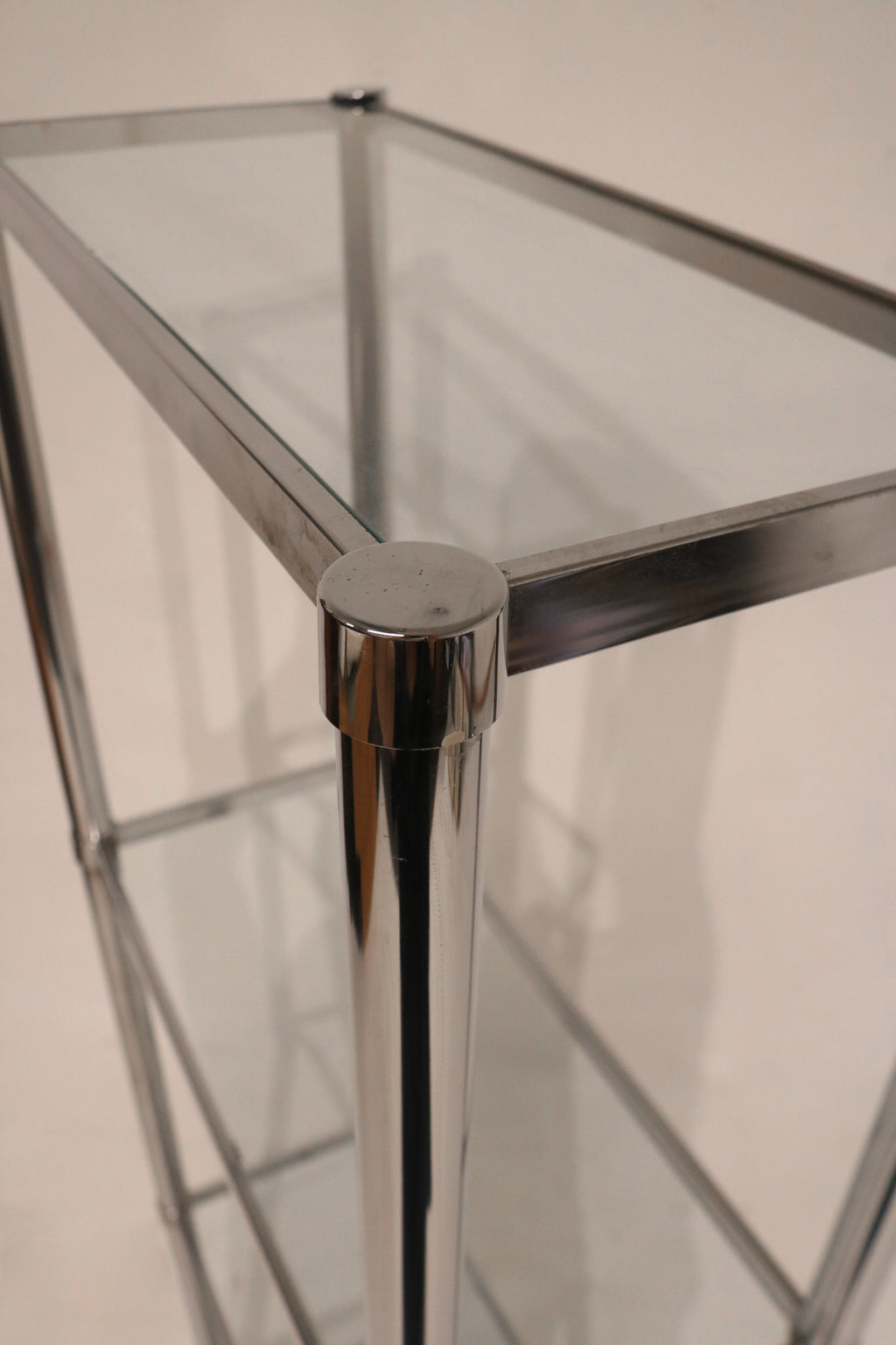 Interior shelf close-up displaying glass texture and chrome support structure