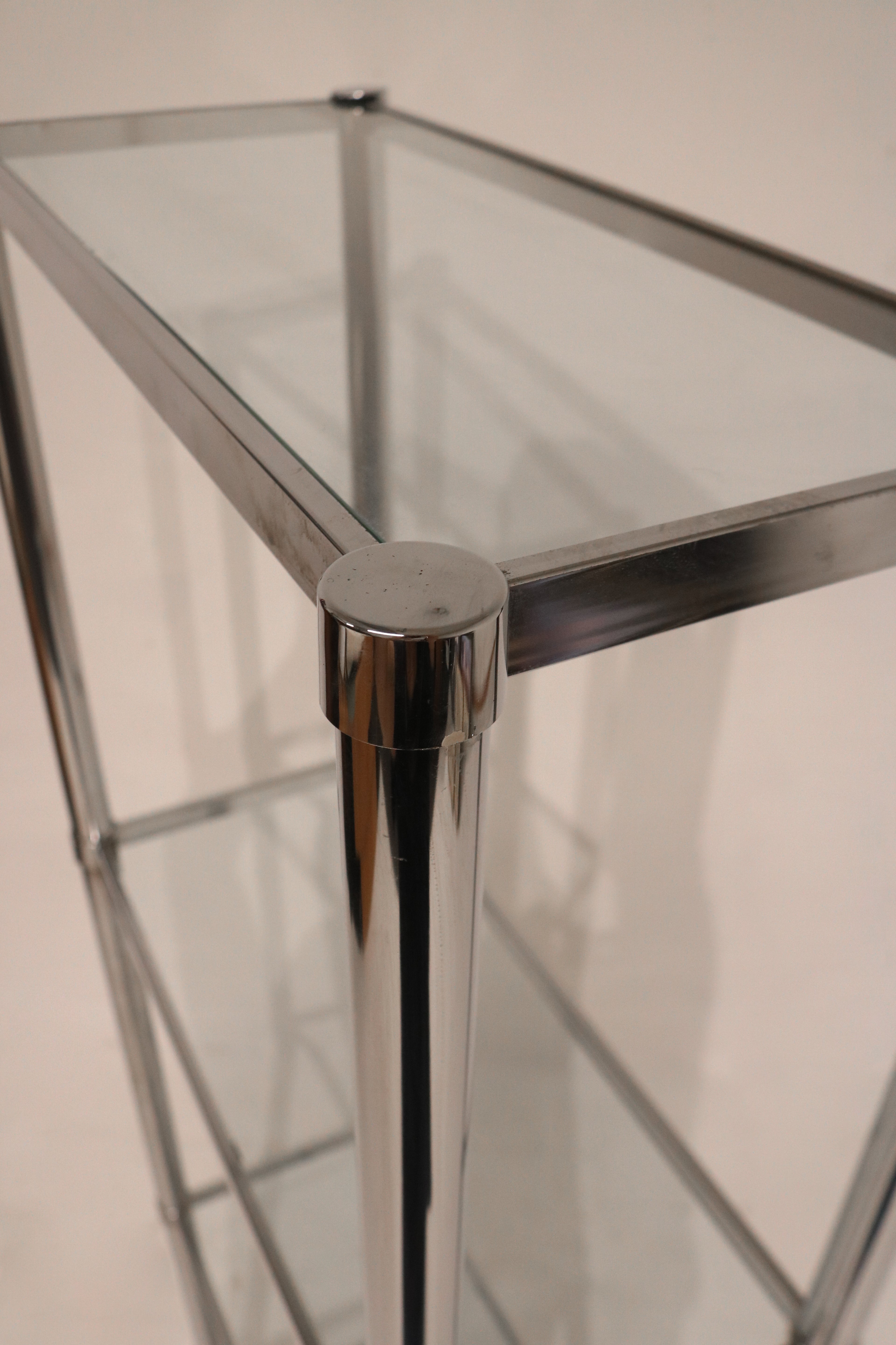 Interior shelf close-up displaying glass texture and chrome support structure