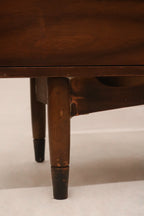 View of the dresser’s side panel highlighting rich walnut wood construction