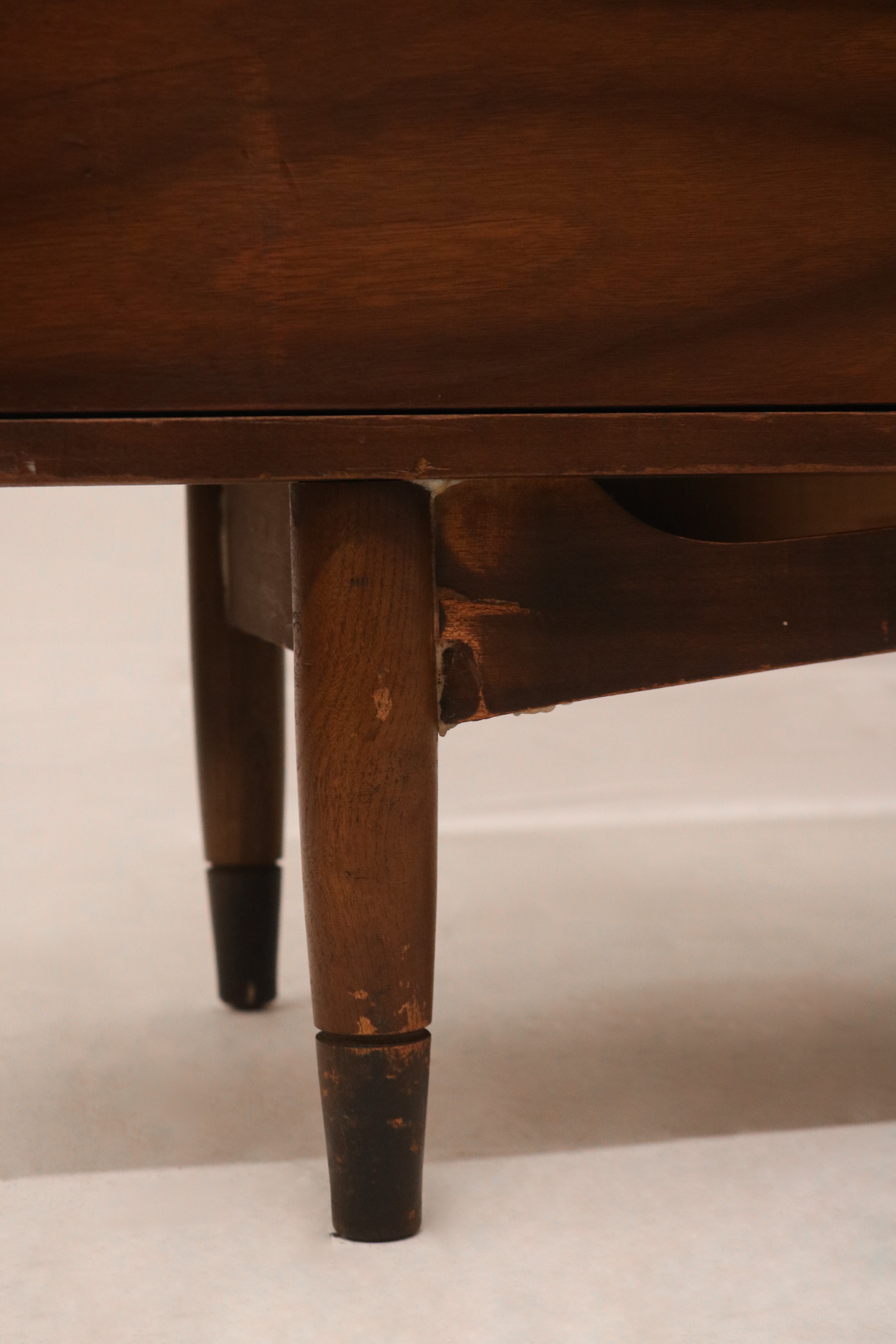 View of the dresser’s side panel highlighting rich walnut wood construction