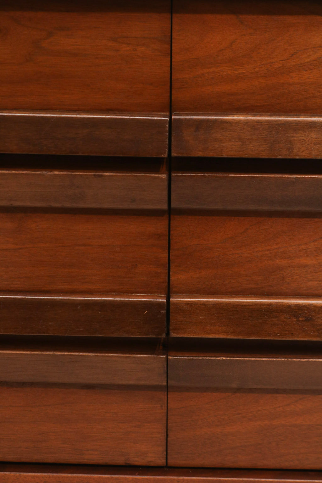 Side view of vintage walnut lowboy dresser showing smooth veneer and mid-century profile
