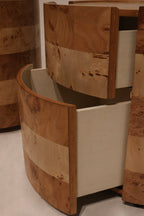 Interior view of open top drawer lined with soft-close rails and rich elm burl veneer