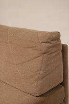 Under-seat view of Mcm modular fabric sofa showing cushion base, fabric lining and support structure indicative of durable MCM build