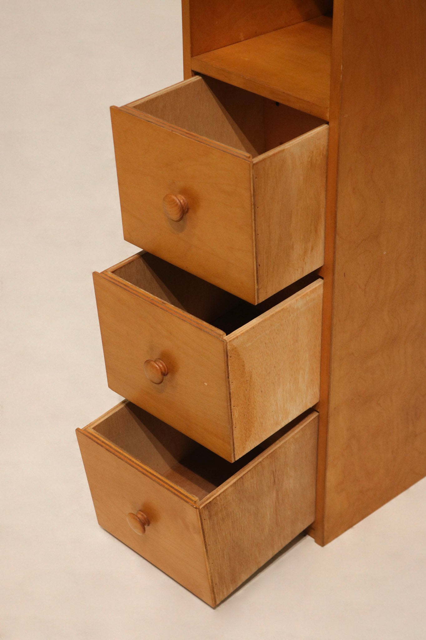 Detail of the hardware and handle finish on drawer of wooden bookcase
