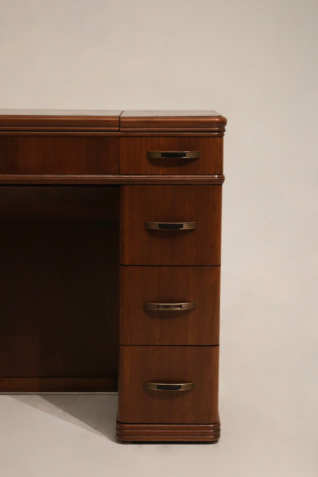 Assembled view with leaves closed of walnut wood small desk showing compact profile and storage-efficient design