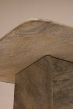 Close-up of marble texture showing natural stone pattern and polished surface on side table