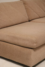 Close shot of small white paint stain on fabric of Mcm modular sectional sofa highlighting blemish location and overall clean condition