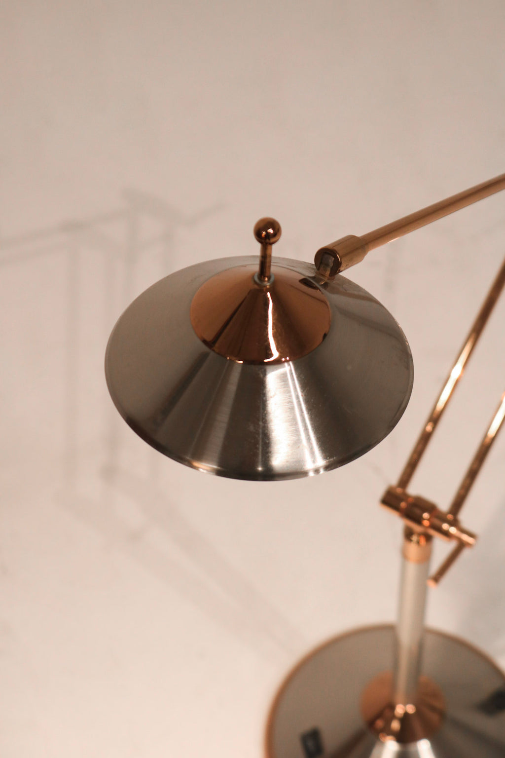 Close-up of lamp cord and base attachment in chrome steel showing quality build