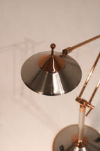 Close-up of lamp cord and base attachment in chrome steel showing quality build