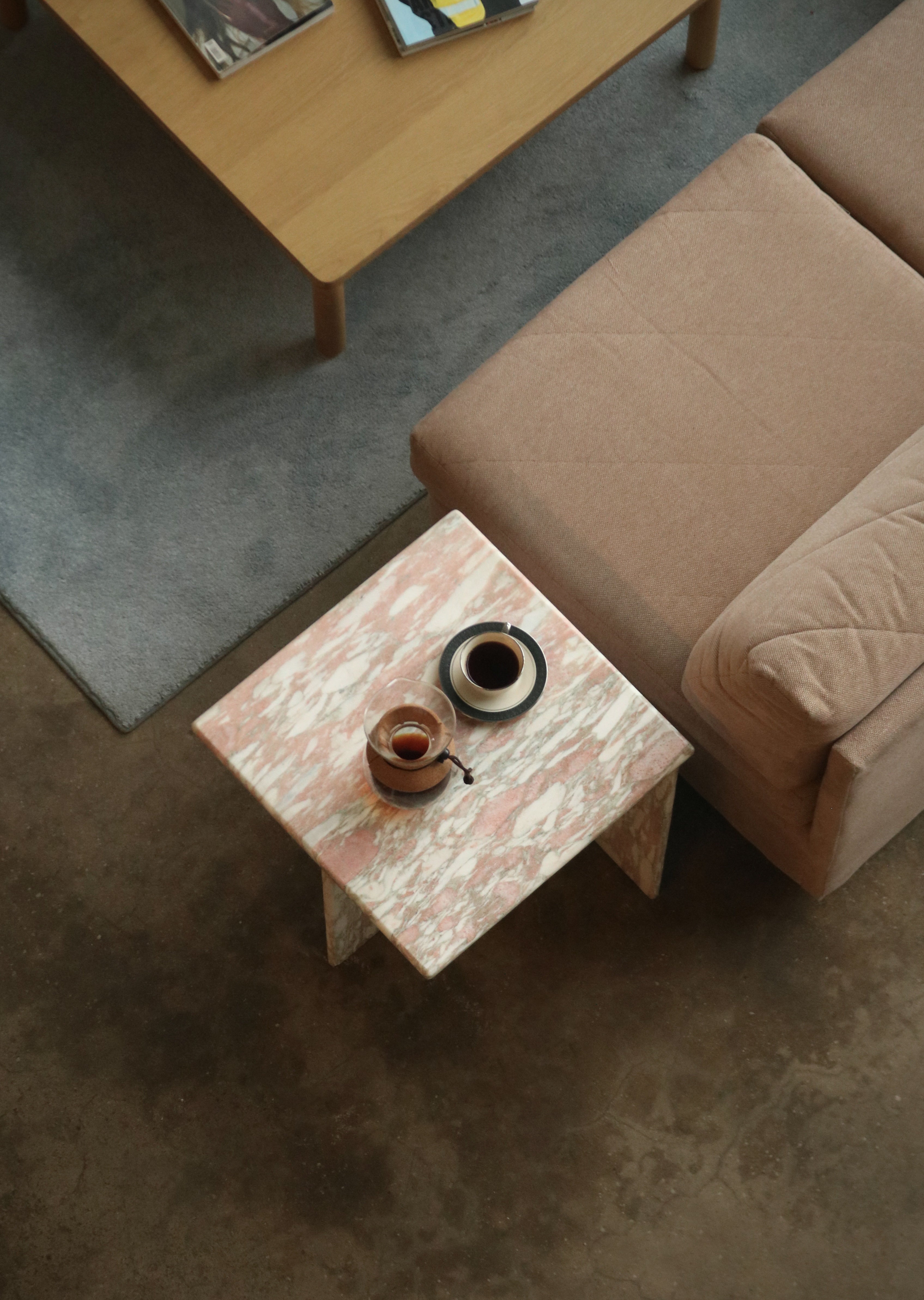 Macro shot emphasizing mineral deposits, fine veining and preserved polished surface on the natural pink solid marble table.