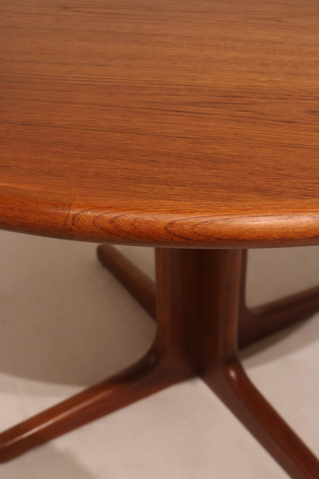 Detail of table edge showing smooth rounded edges and solid teak wood construction