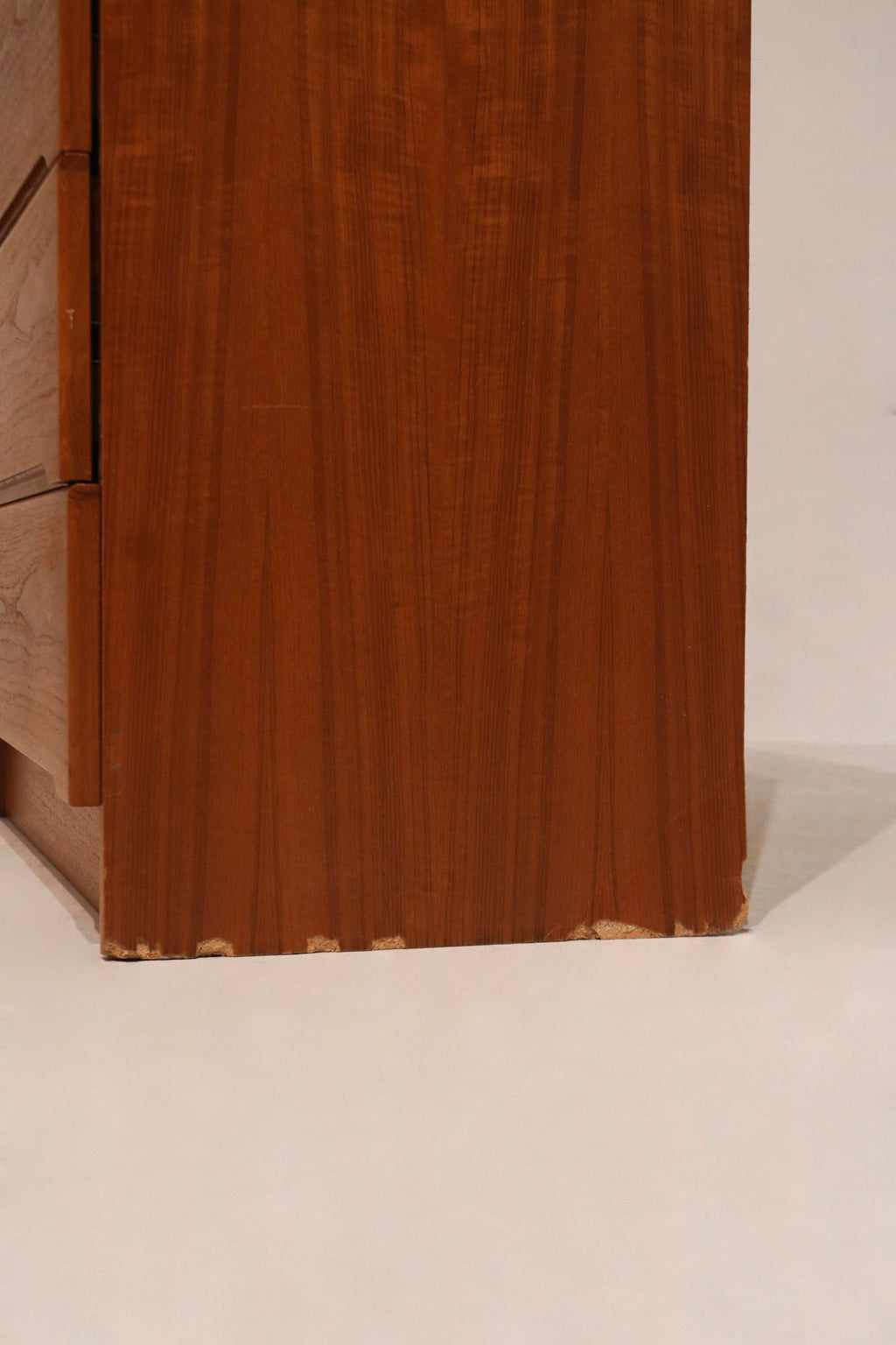 Close-up of dresser’s base and legs showing solid teak construction
