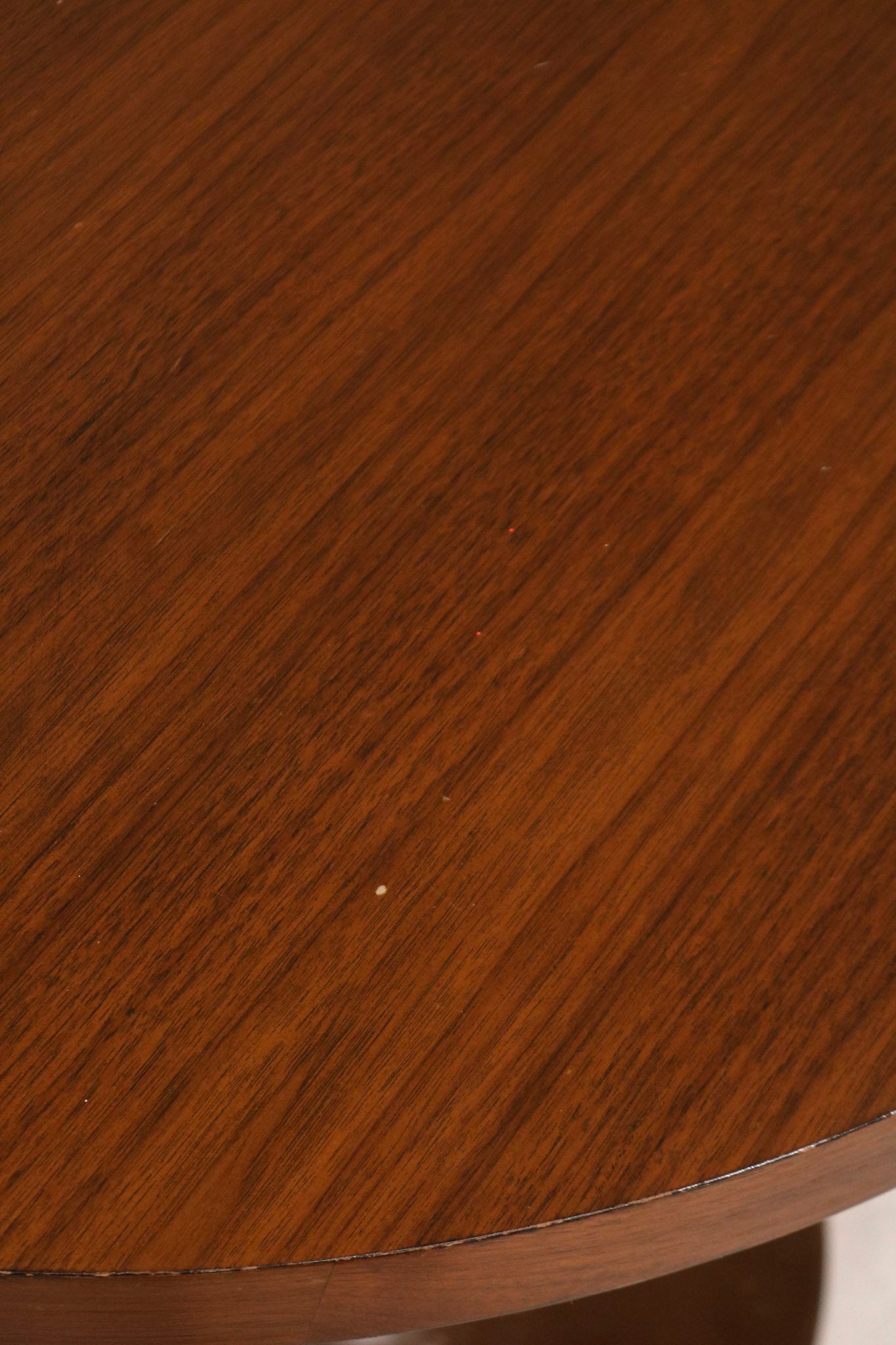 Close-up of table leg and joint area showing robust wood build and slight wear