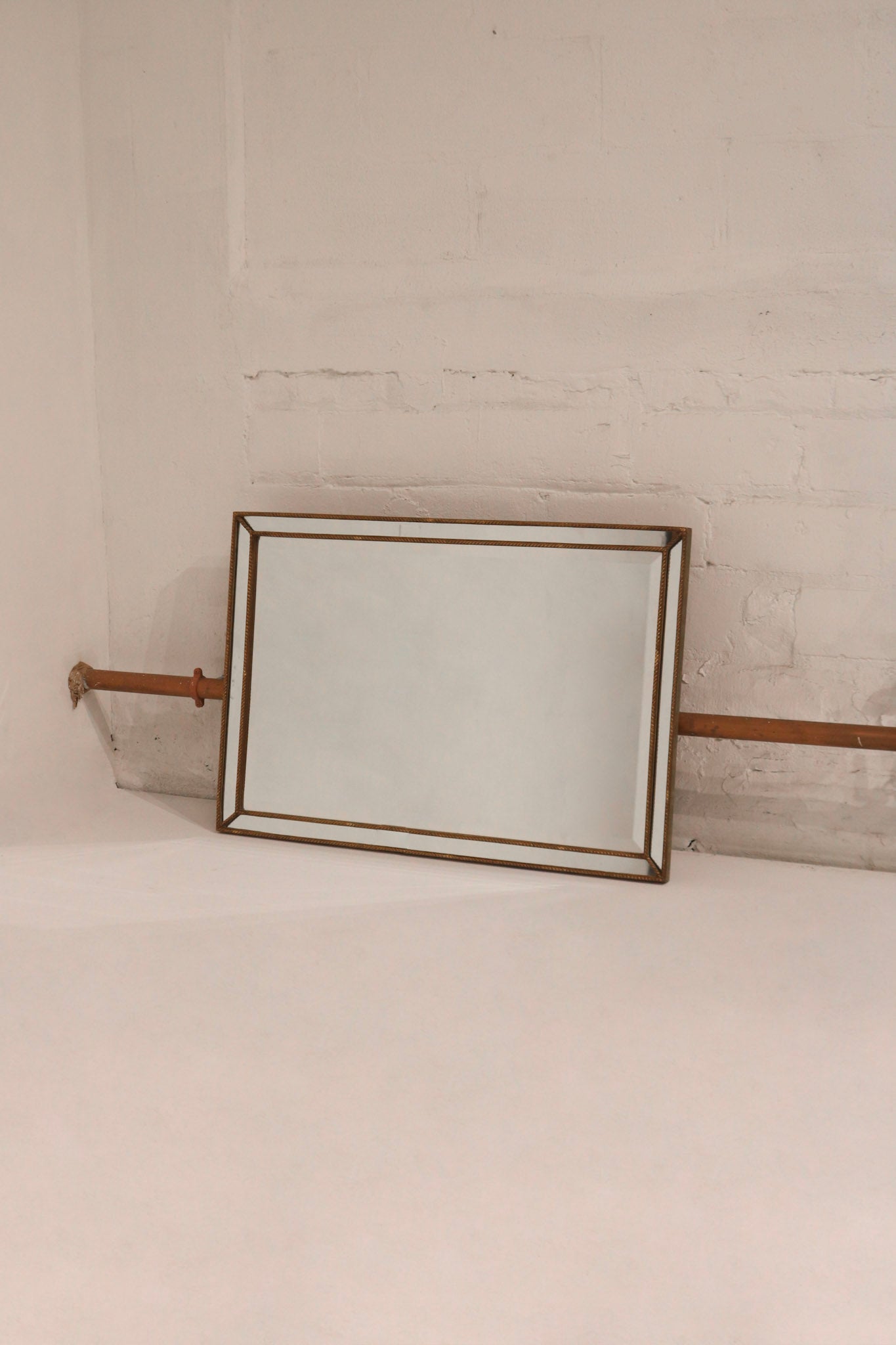 Full view of vintage wooden wall mirror with golden frame, made from solid wood and glass, in excellent condition