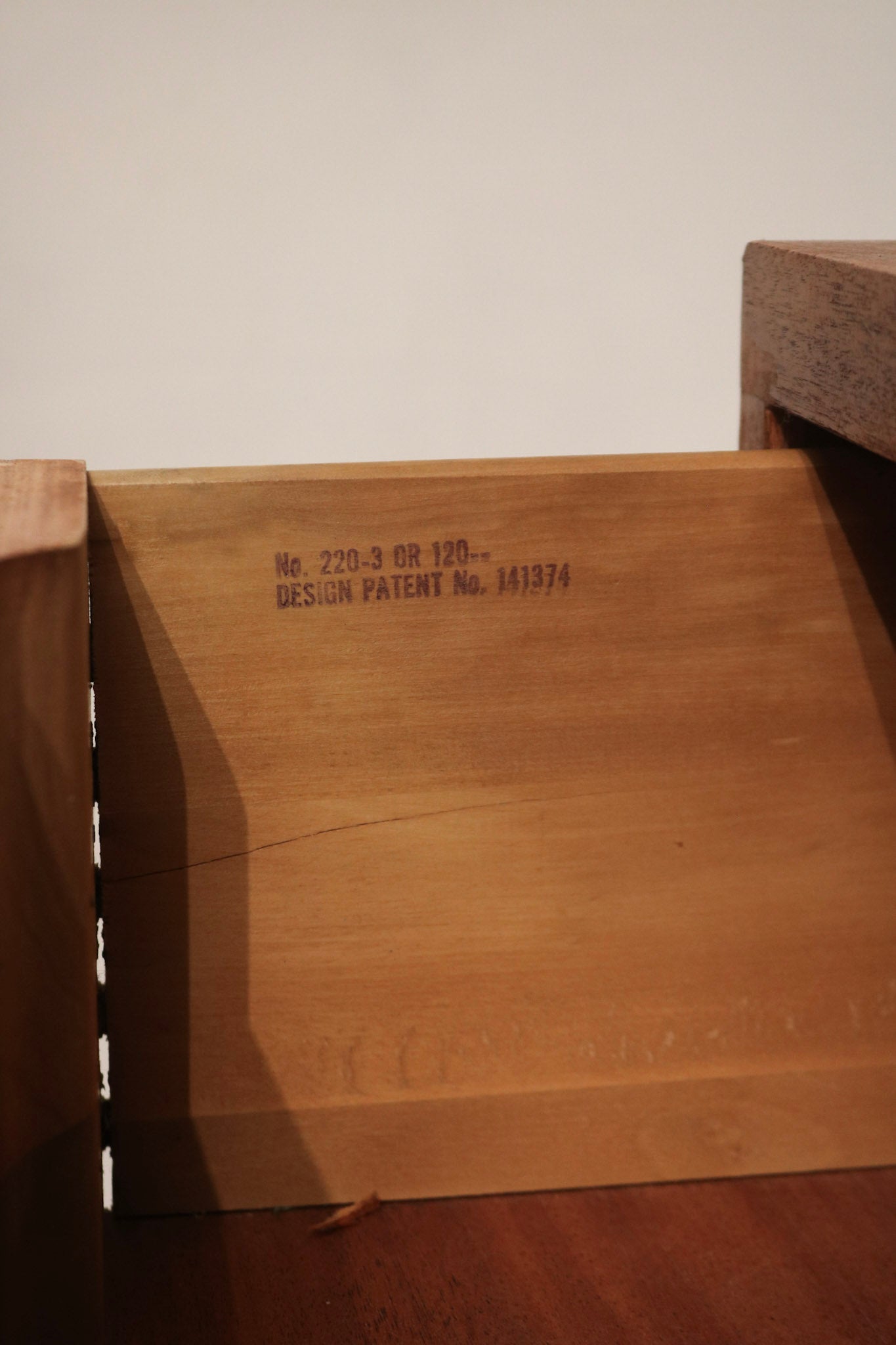 Close-up of lower base and floor contact on solid wood dresser chest, heavy weight distribution and durable construction evident