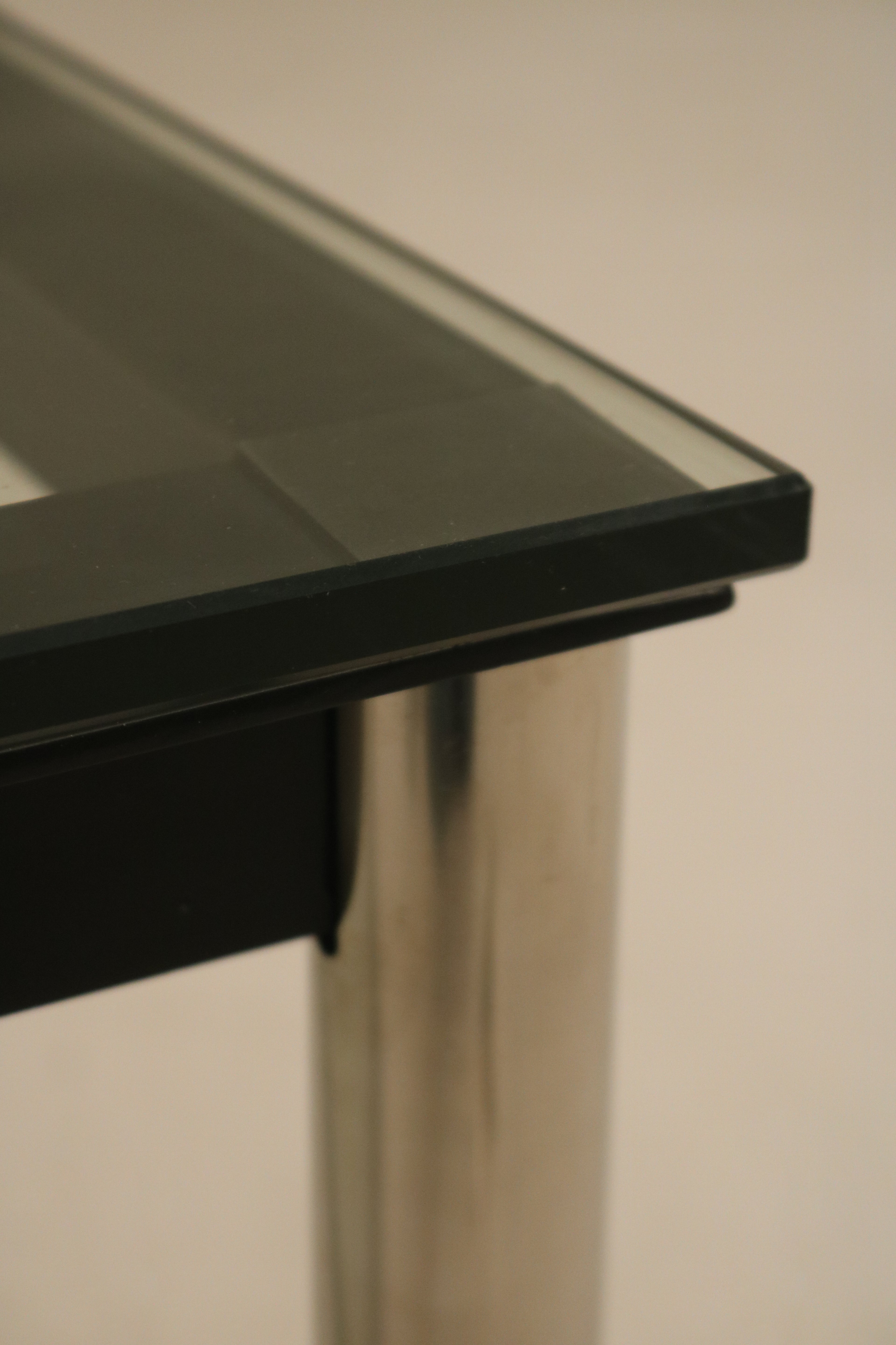 Side angle showing corner connection between glass top and steel frame on Mcm coffee table