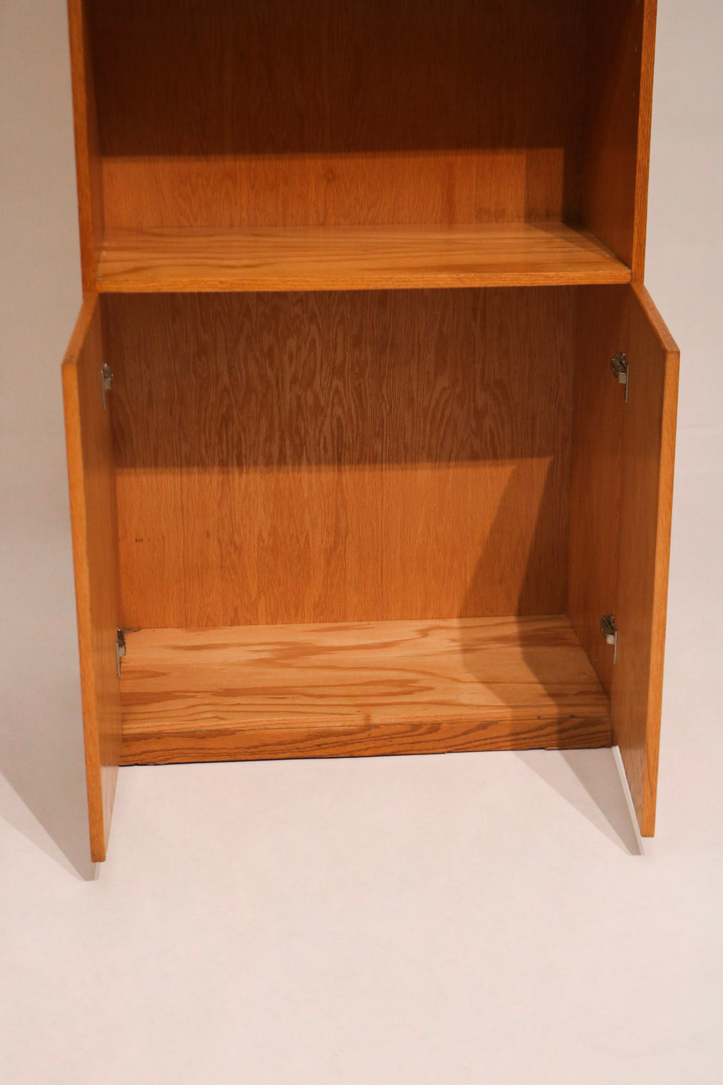 Side profile of Mcm tall bookcase highlighting solid oak frame and slim silhouette