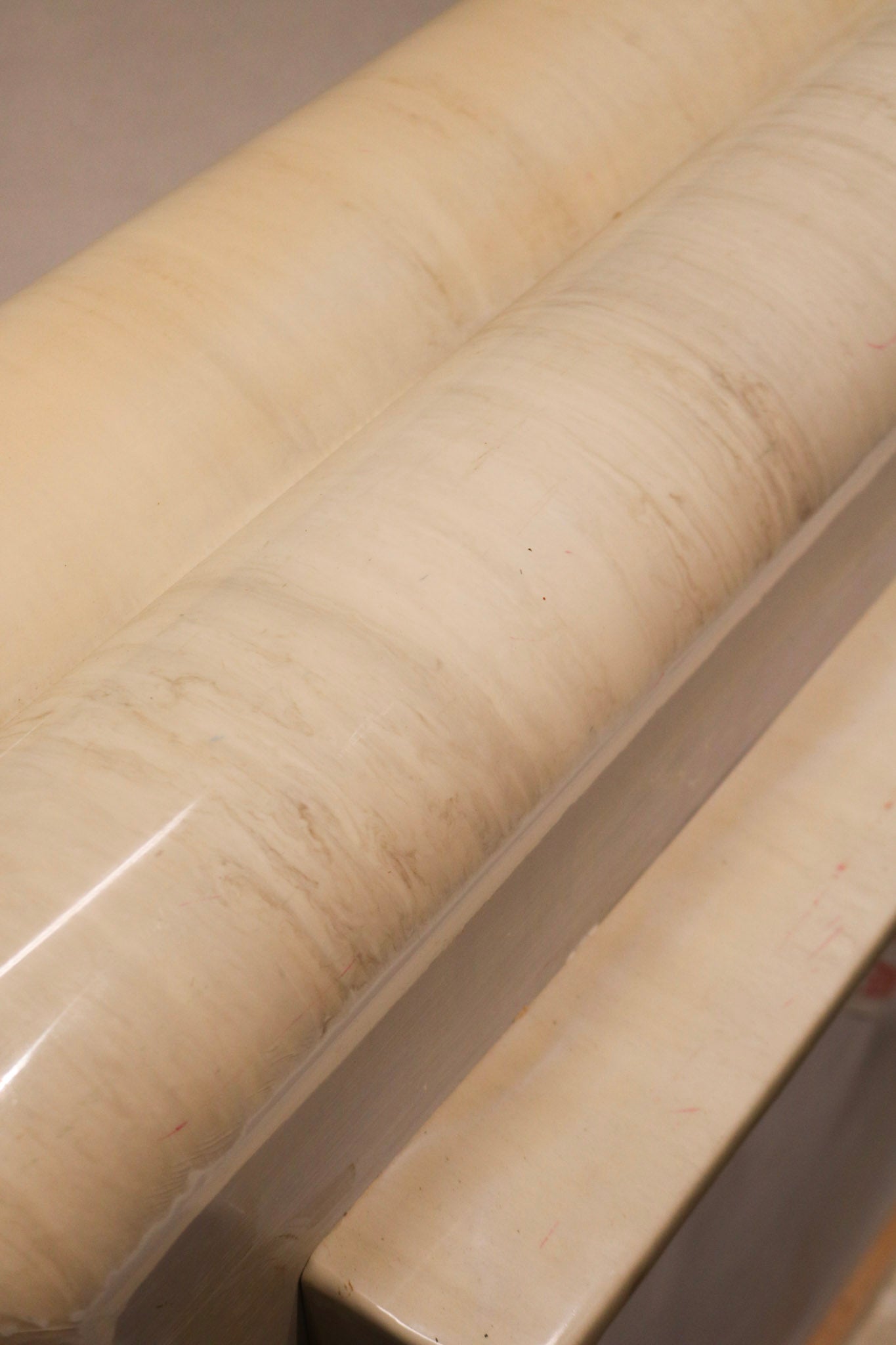 Close-up of resin finish showcasing marbled texture and high-gloss surface from 1980s design