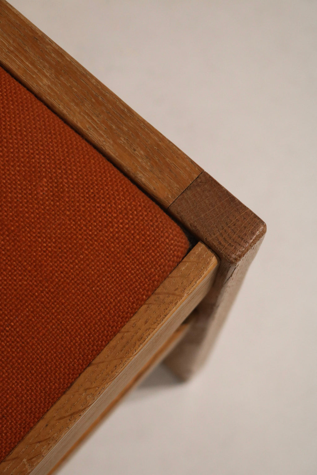 Top view of seats showing uniform orange tweed upholstery, seat contours, consistent condition and visible minor surface wear.