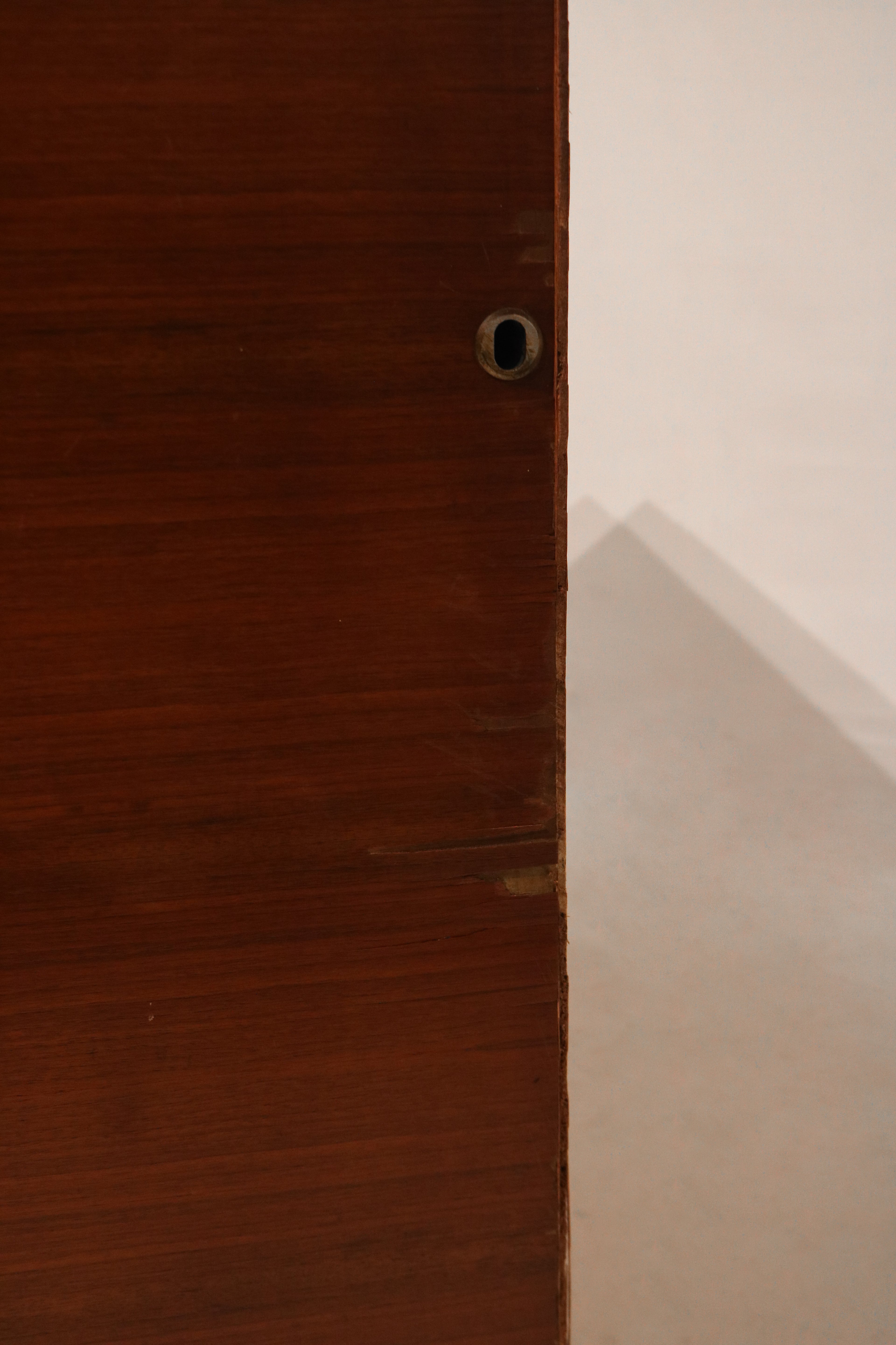 Detailed corner view showing curved Art Deco edges and natural grain wood texture